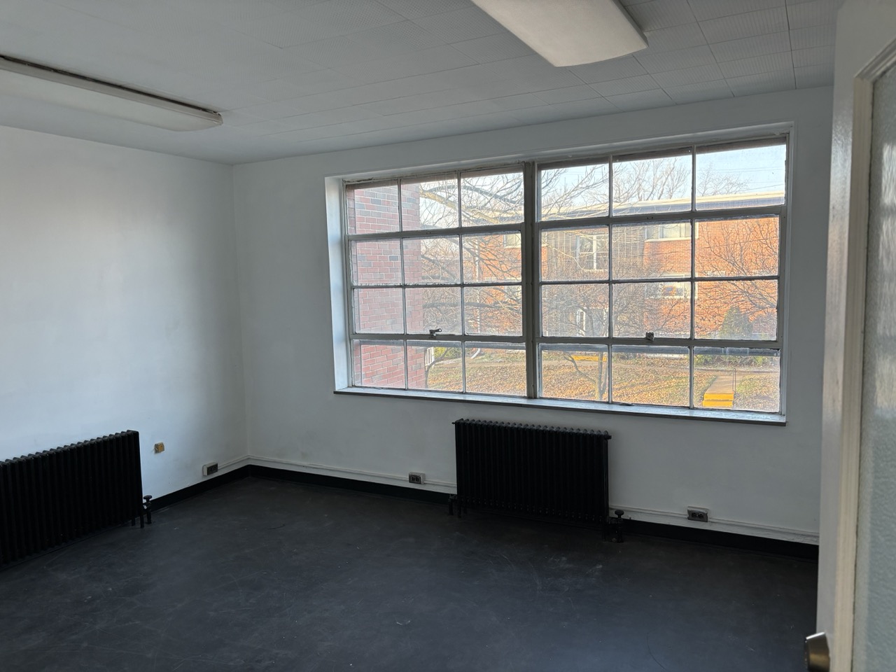 Private team office with large industrial windows and natural light